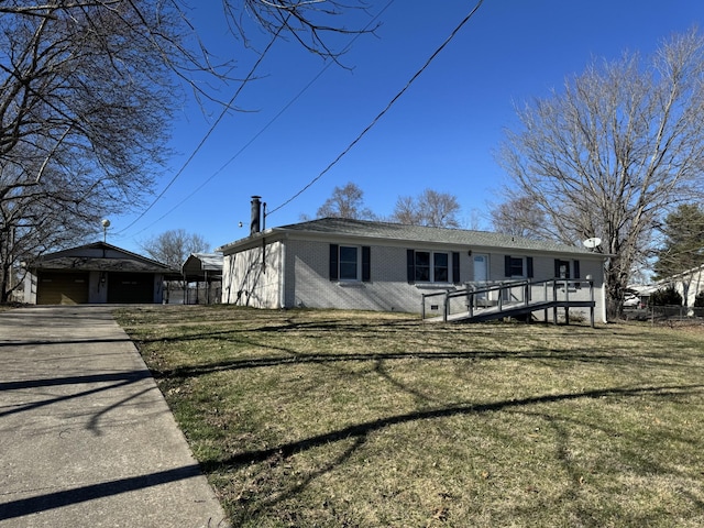 view of front of property with a garage, a front lawn, and brick siding