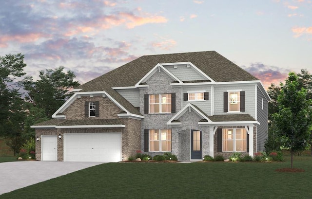 craftsman-style house featuring a garage, concrete driveway, a yard, and a shingled roof