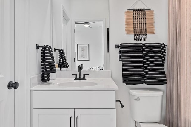 half bathroom featuring toilet and vanity