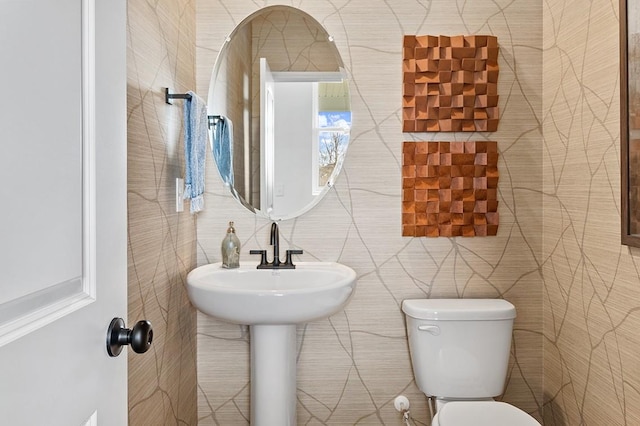 bathroom with toilet and tile walls