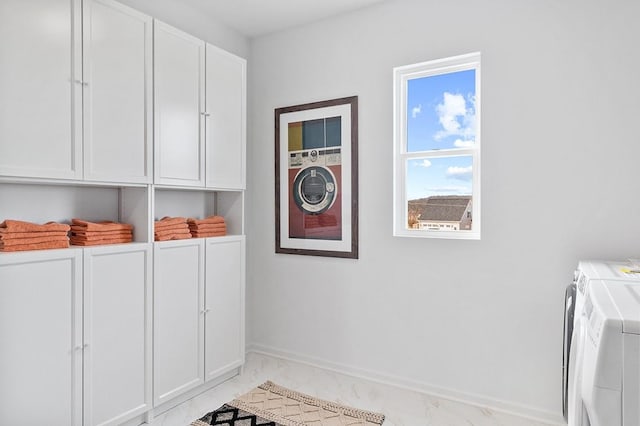 laundry room featuring independent washer and dryer, baseboards, marble finish floor, and cabinet space