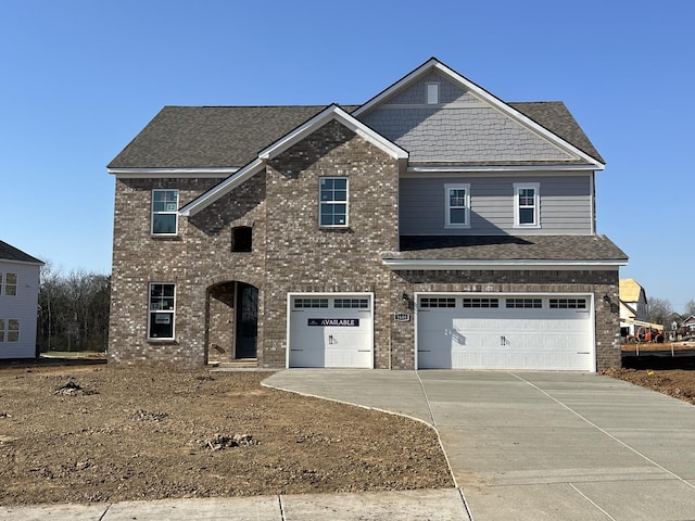 view of front of home featuring brick siding, roof with shingles, concrete driveway, and an attached garage