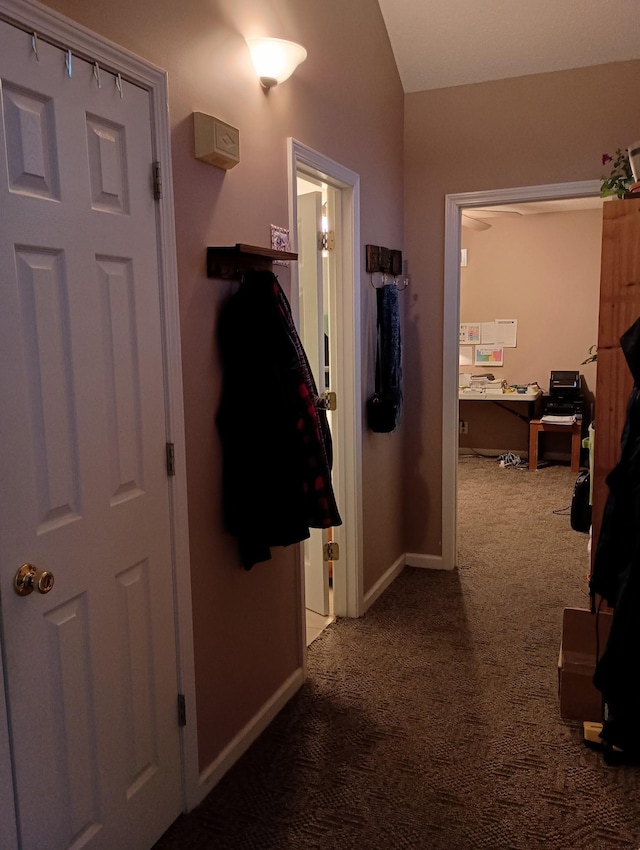 corridor with carpet flooring and baseboards