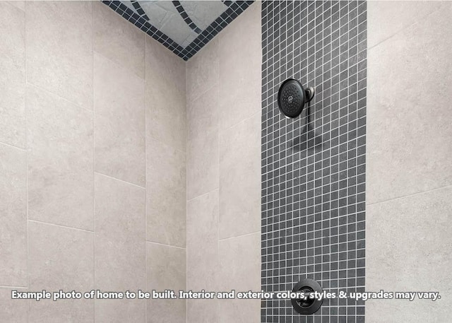 interior details with a tile shower