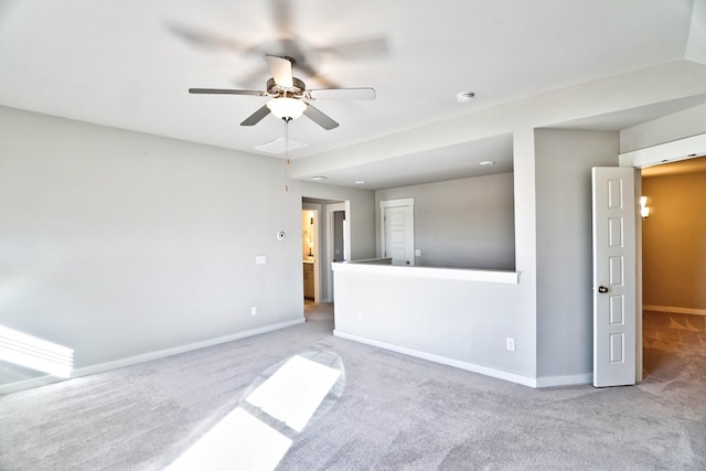 spare room featuring a ceiling fan, carpet, and baseboards