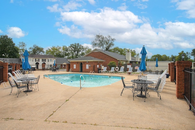 pool featuring a patio area and fence