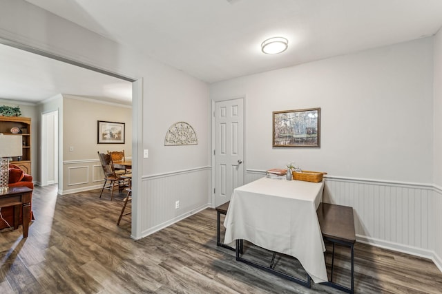 dining space featuring wainscoting and dark wood finished floors