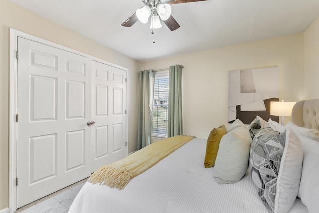 bedroom with a ceiling fan and a closet