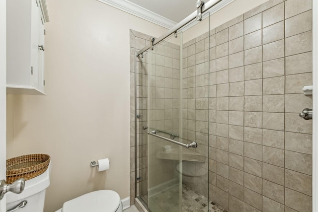 full bath featuring ornamental molding, a shower stall, and toilet