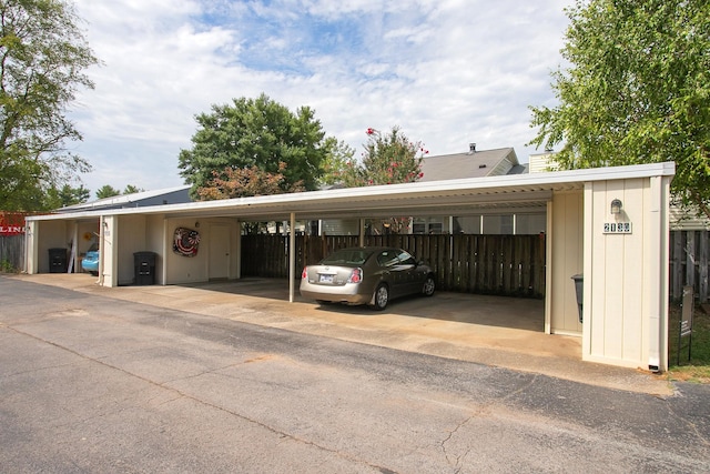 view of car parking featuring fence