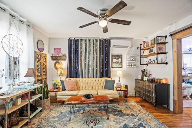 living area featuring ceiling fan, a wall unit AC, and wood finished floors