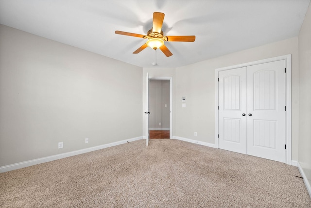 unfurnished bedroom with a ceiling fan, carpet, baseboards, and a closet