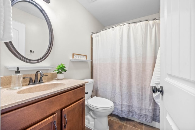 bathroom with toilet, curtained shower, tile patterned flooring, and vanity