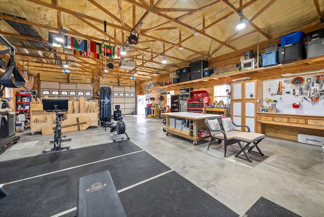 garage featuring a garage door opener and a workshop area