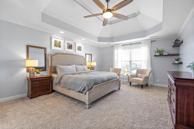 bedroom with a raised ceiling, light colored carpet, ornamental molding, a ceiling fan, and baseboards