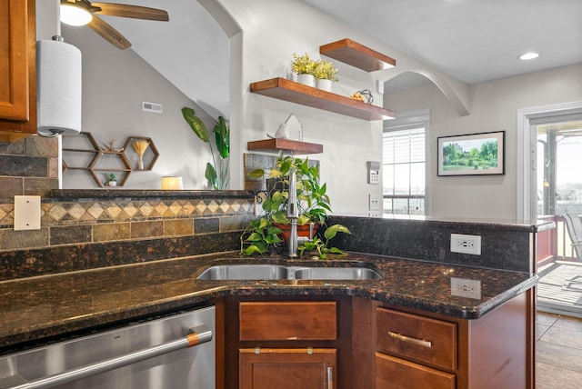 kitchen featuring a sink, plenty of natural light, stainless steel dishwasher, and open shelves