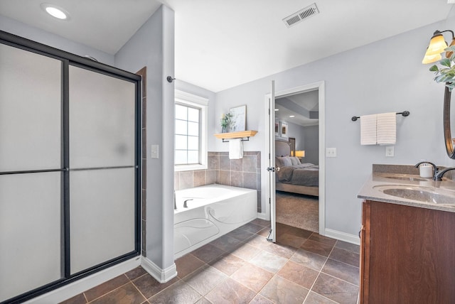 ensuite bathroom with a stall shower, visible vents, ensuite bath, a garden tub, and a sink