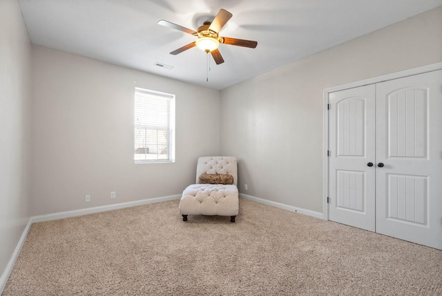 unfurnished room with ceiling fan, carpet, visible vents, and baseboards