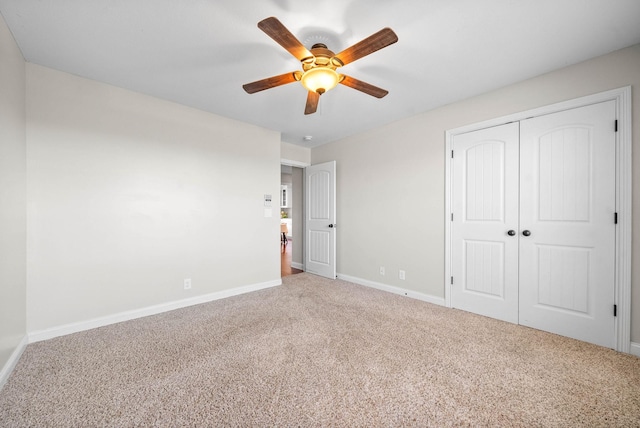 unfurnished bedroom featuring ceiling fan, a closet, carpet, and baseboards