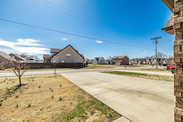 view of yard with a residential view and fence