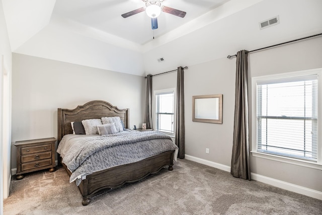 bedroom featuring lofted ceiling, a ceiling fan, visible vents, baseboards, and carpet