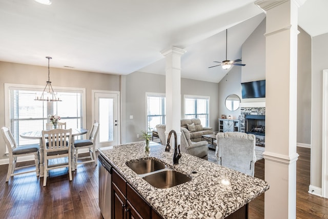 kitchen with decorative columns, dishwasher, dark wood-type flooring, dark brown cabinets, and a sink