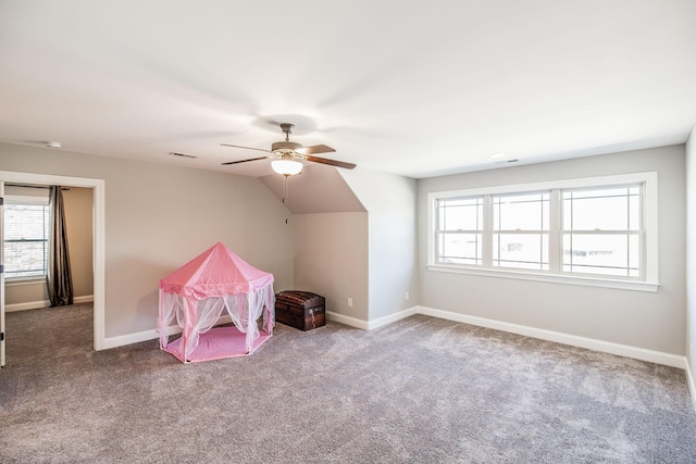 recreation room featuring visible vents, baseboards, a ceiling fan, lofted ceiling, and carpet