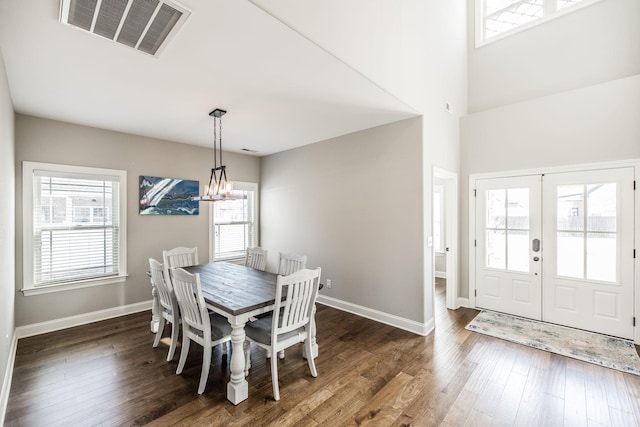 dining space with plenty of natural light, visible vents, and wood finished floors