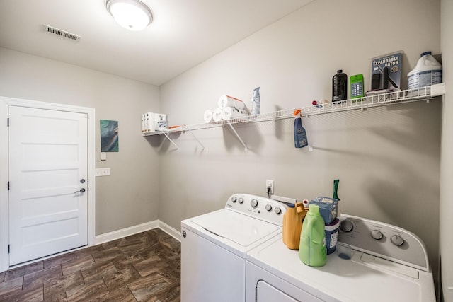 laundry room with laundry area, baseboards, visible vents, stone finish flooring, and washer and dryer