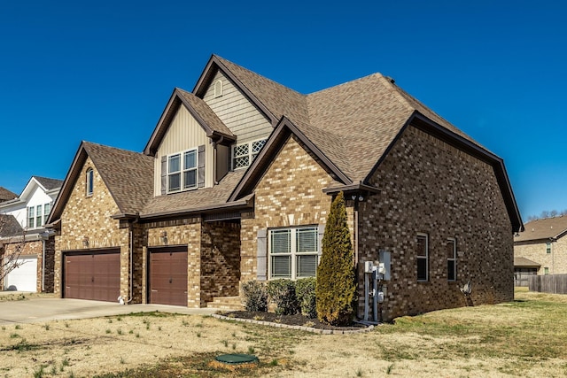 view of front of house featuring a garage, concrete driveway, roof with shingles, fence, and brick siding