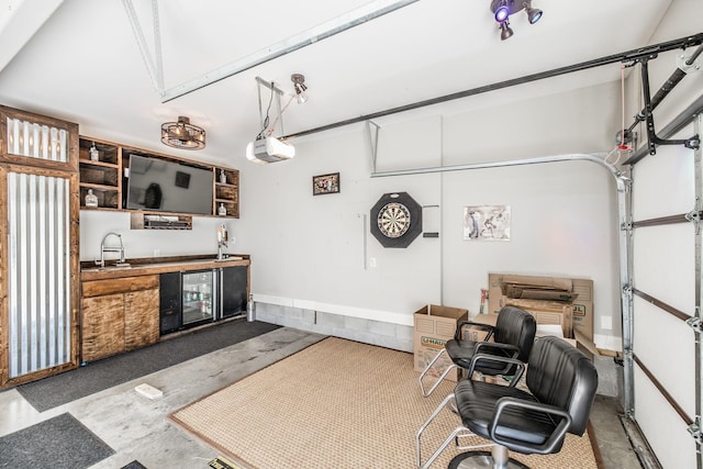 garage with beverage cooler and a sink