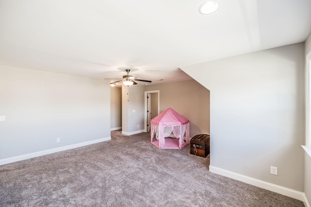 playroom with a ceiling fan, carpet flooring, and baseboards