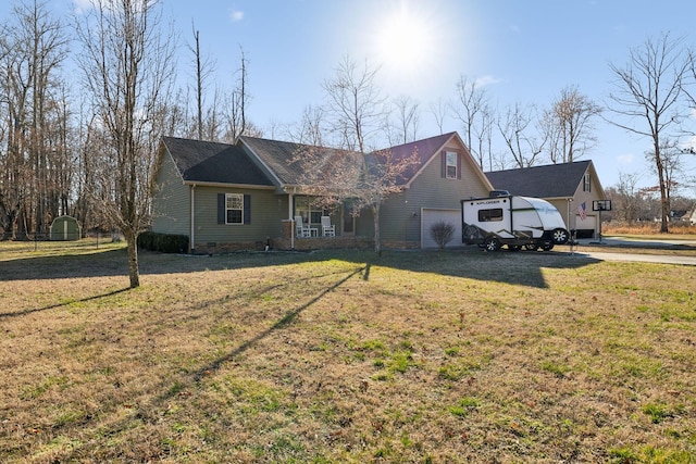 view of front of property with crawl space, a porch, a front lawn, and a shed