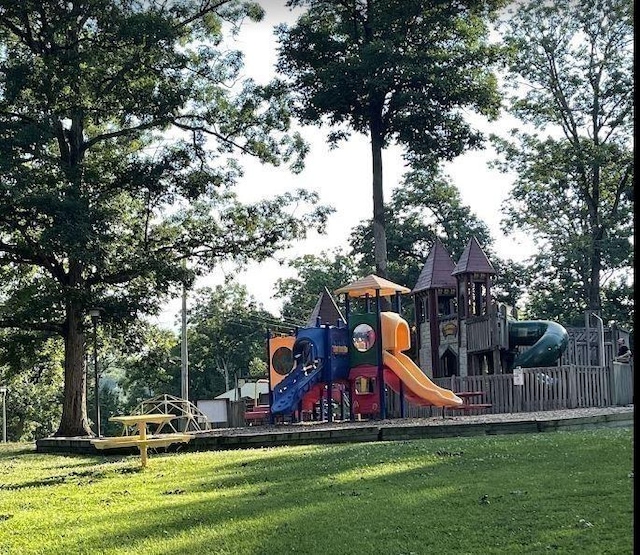 community jungle gym featuring a lawn