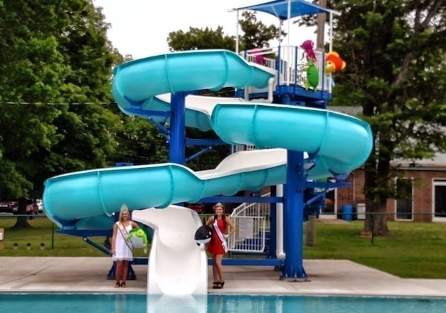 exterior space featuring playground community and a water slide