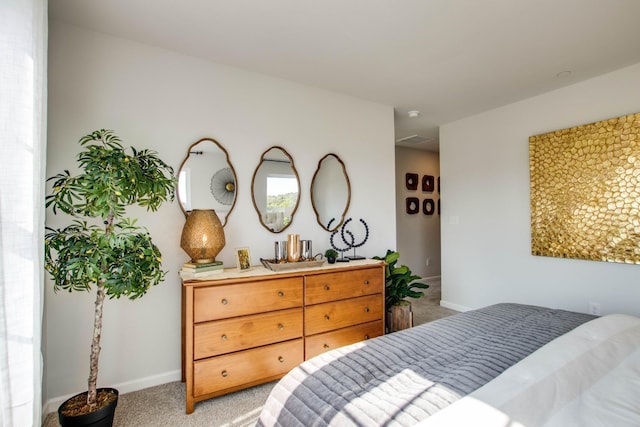 bedroom featuring light carpet and baseboards