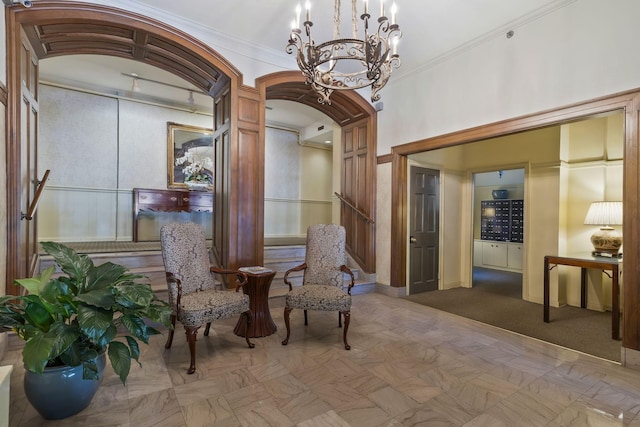 sitting room with arched walkways, a notable chandelier, and crown molding