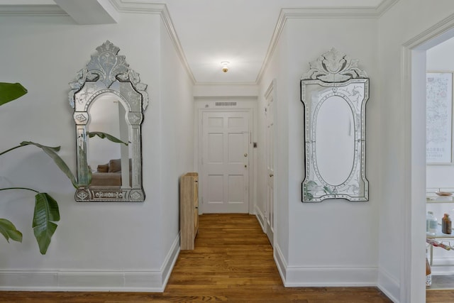 corridor with crown molding, baseboards, and wood finished floors