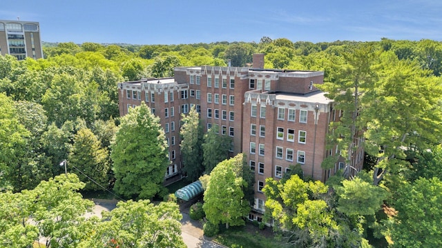 view of building exterior with a forest view