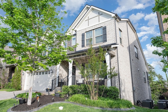 craftsman-style home with brick siding, driveway, and central AC