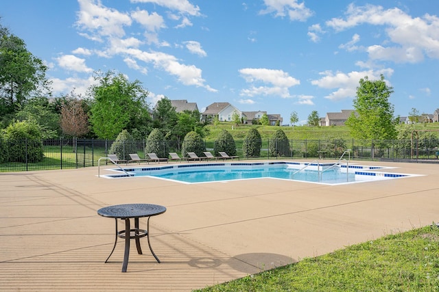 pool with fence and a patio