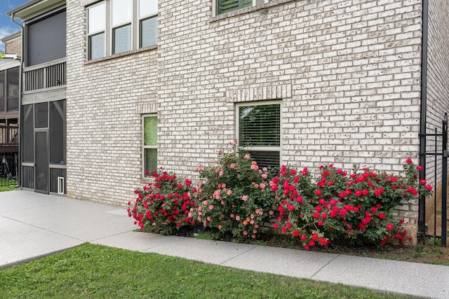 view of side of home featuring brick siding