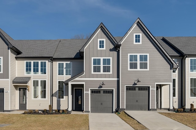 view of property featuring driveway, board and batten siding, an attached garage, and roof with shingles