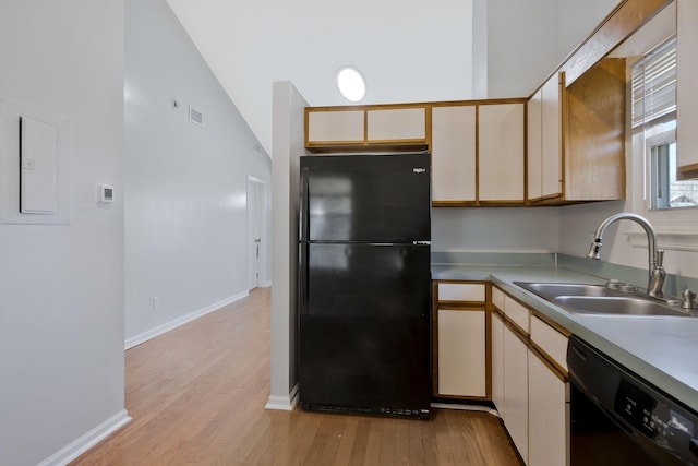 kitchen with visible vents, light wood-style flooring, light countertops, black appliances, and a sink