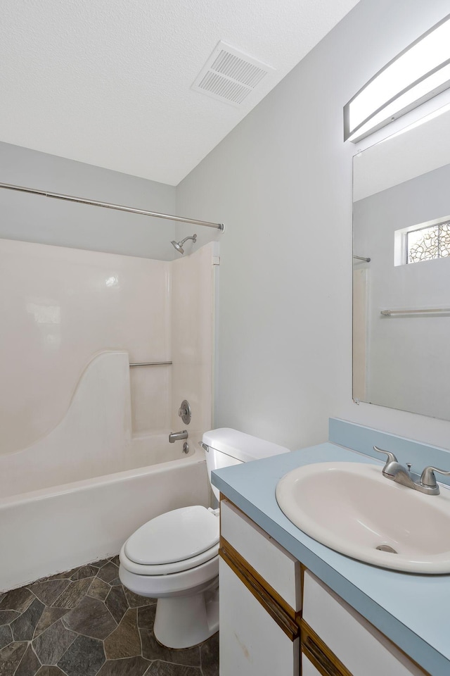 full bath featuring bathtub / shower combination, visible vents, toilet, vanity, and a textured ceiling