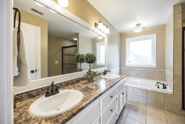 full bath featuring a stall shower, tile patterned flooring, visible vents, and a sink