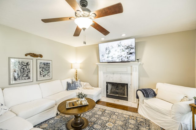 living room featuring ceiling fan, wood finished floors, a high end fireplace, and recessed lighting