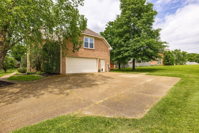 view of side of home featuring a garage, brick siding, a lawn, and driveway