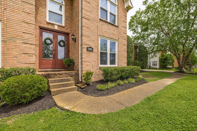 view of exterior entry with french doors and brick siding