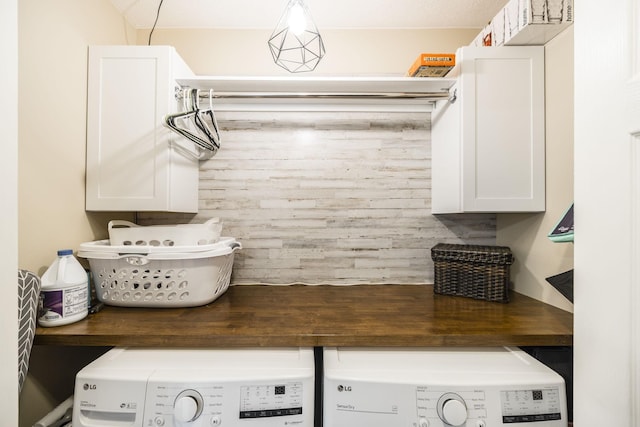 laundry area featuring cabinet space and washer and clothes dryer